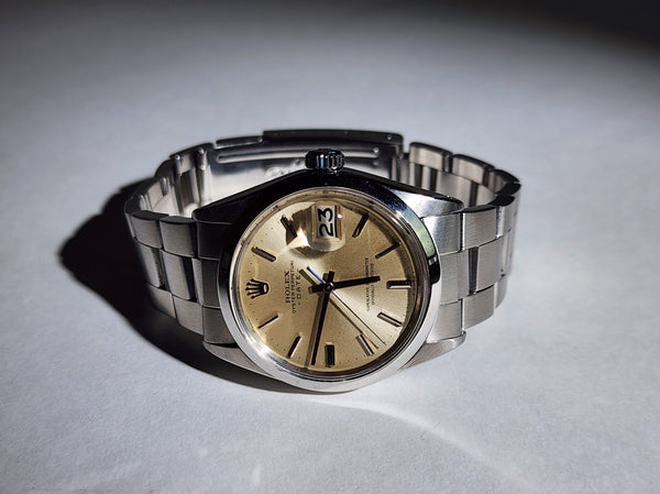 Vintage Rolex Date with original champagne dial and an original stainless steel band.